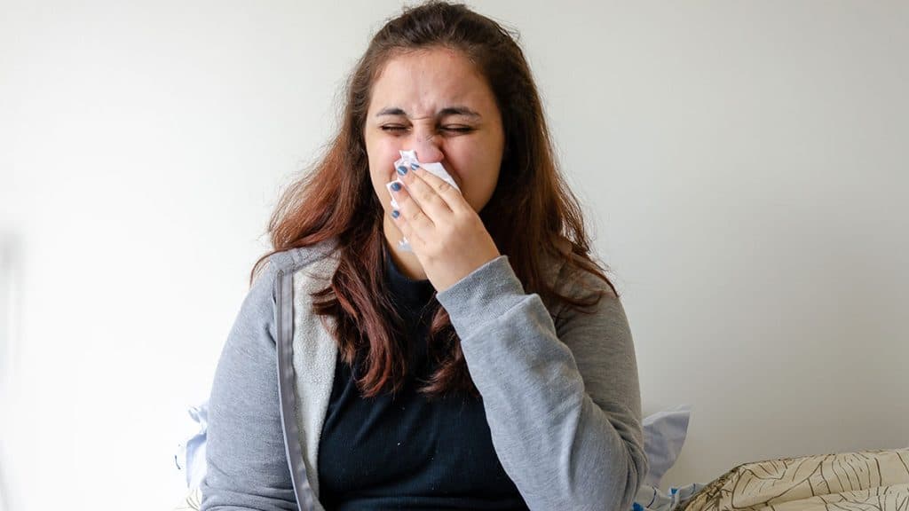 woman sneezing from indoor quality issues