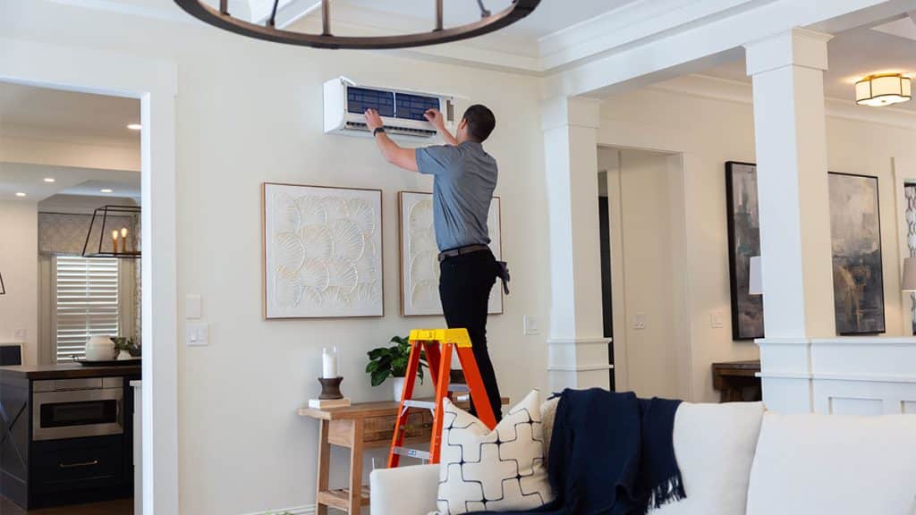 Air conditioning technician installing a Mitsubishi mini split system