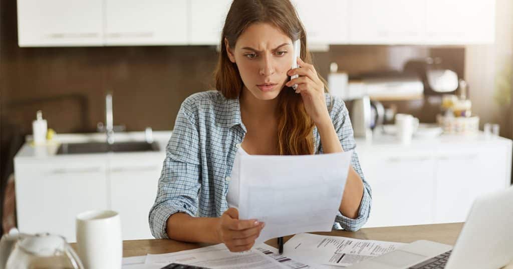 business woman looking at high summer ac bill