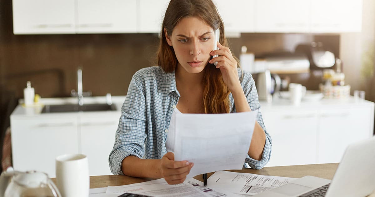 business woman looking at high summer ac bill