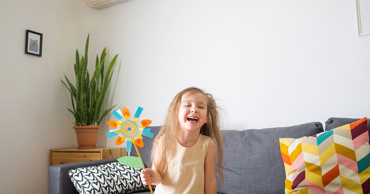 happy young girl holding flower in the cool ac