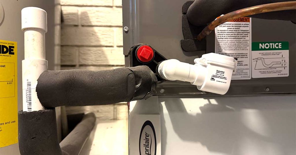 AC condensate drain line with insulated PVC piping and a white RectorSeal safety float switch attached to an indoor HVAC unit.