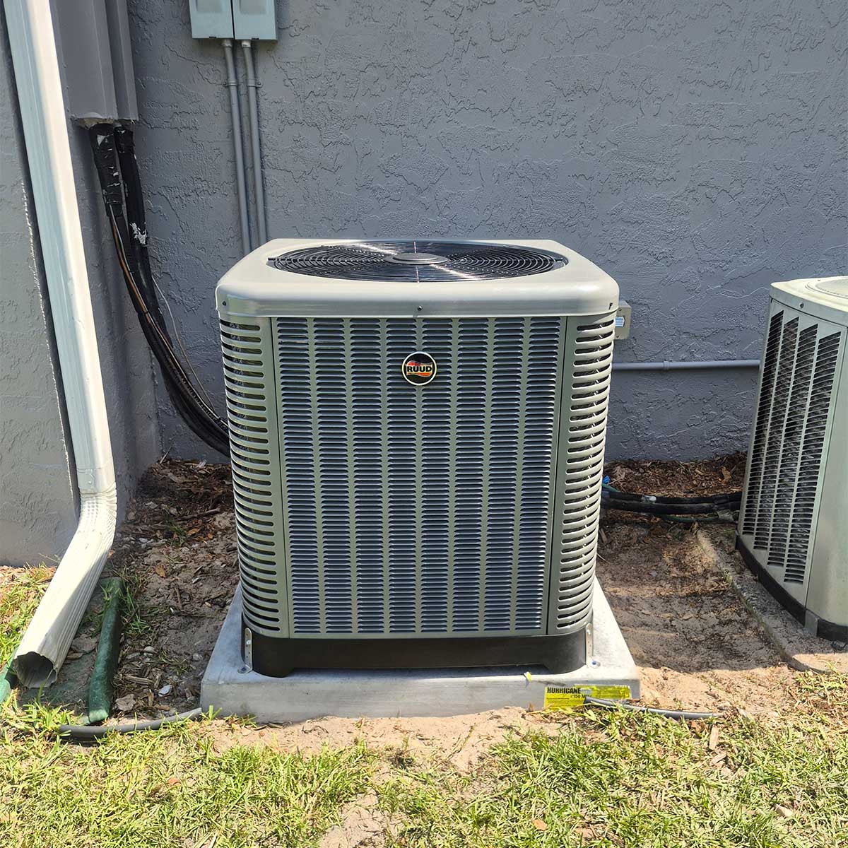 Newly installed residential heat pump outdoor unit sitting on a concrete pad